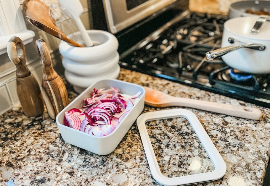 caraway food storage container with red onions inside