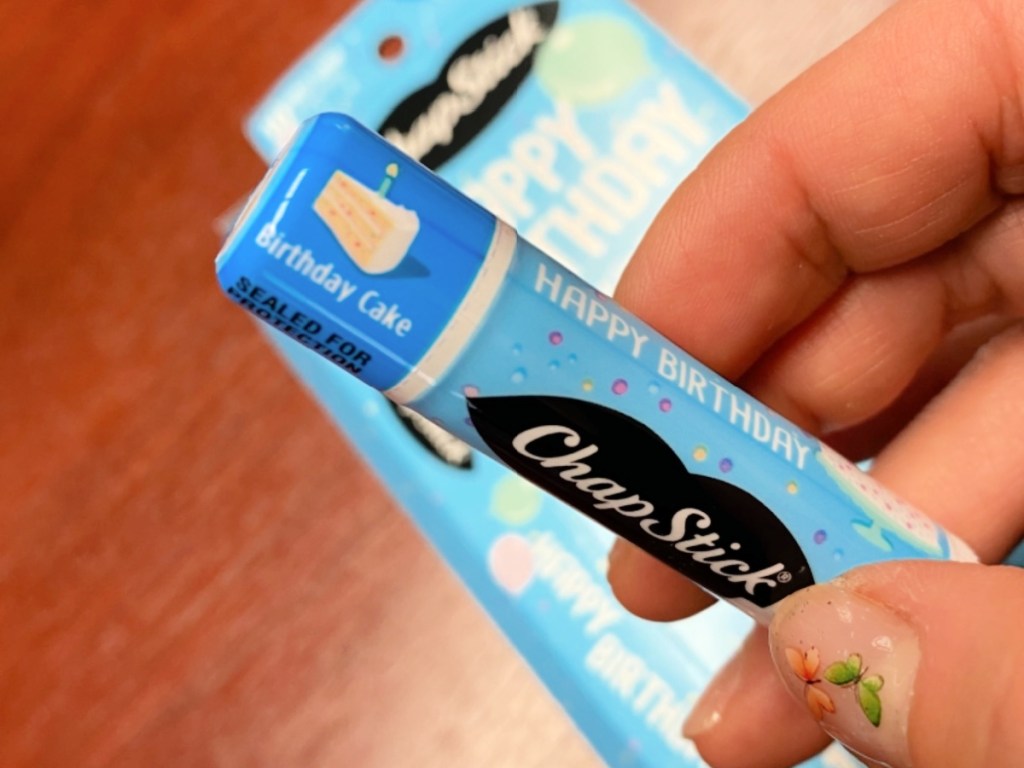 woman holding up a chapstick birthday cake flavored balm