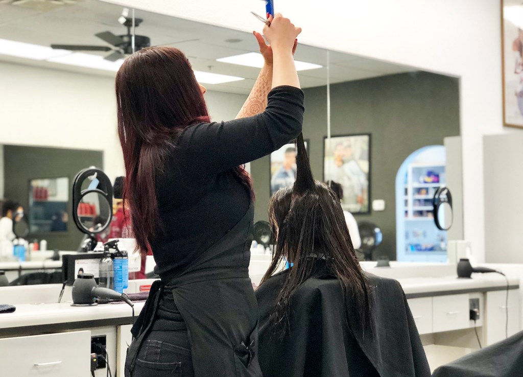 child getting hair cut at salon