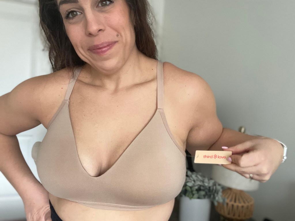 woman holding out tag on thirdlove wireless bra