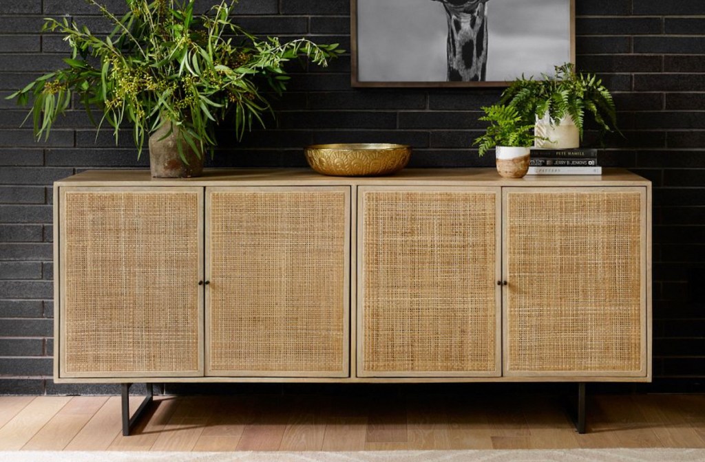 caned console table against black accent wall