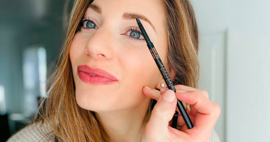 woman using Anastasia Beverly Hills Brow Wiz Ultra-Slim Precision Brow Pencil