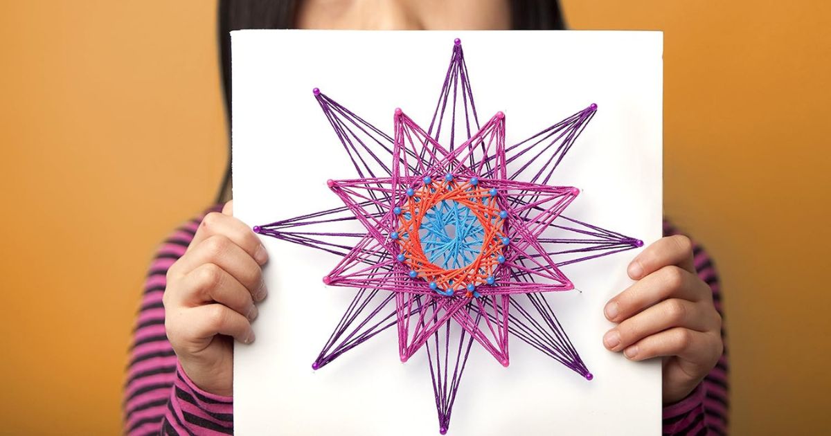 girl holding string art