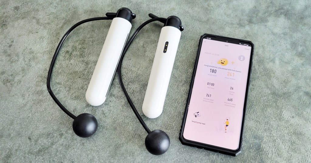 smart jump rope handles next to phone