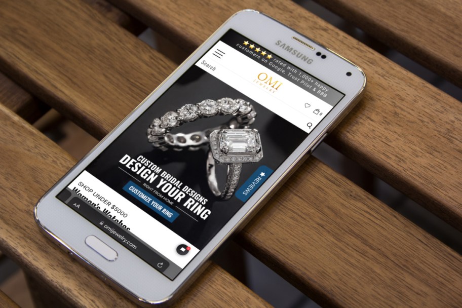 the omi jewelry website, a place with online layaway, shown on a phone