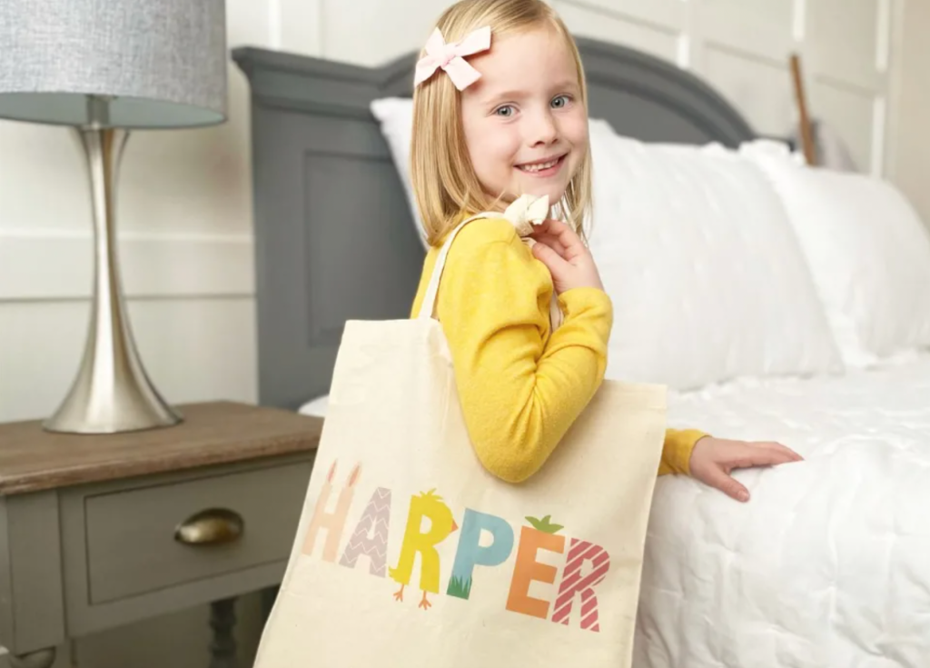 girl with blonde hair with tote on shoulder