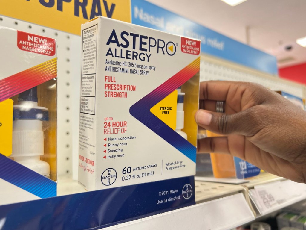 hand holding astepro nasal spray 