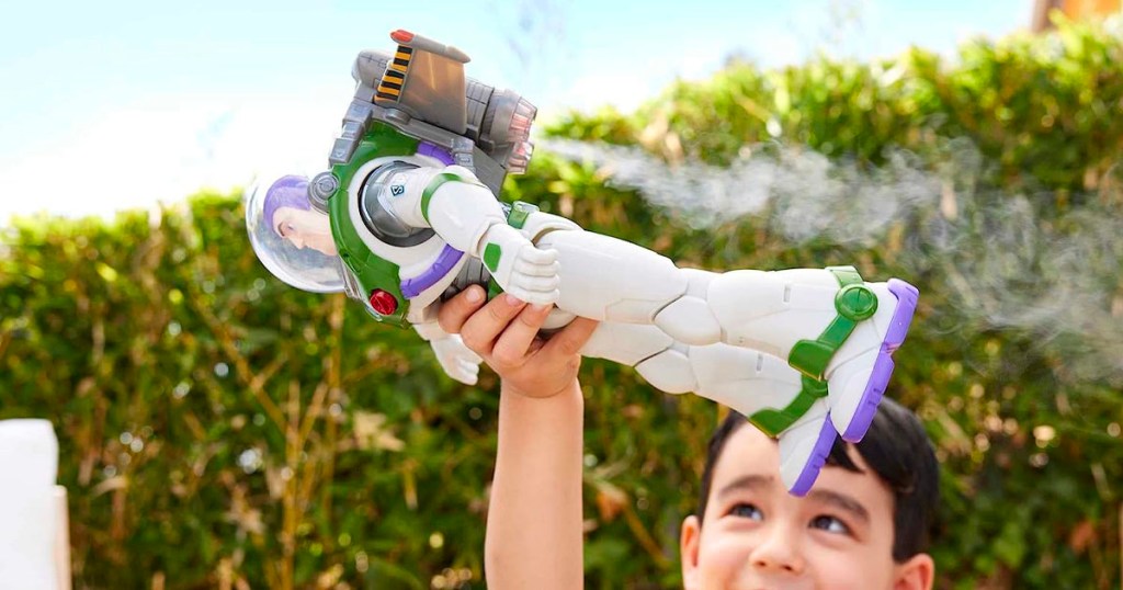 child holding up a buzz light year toy