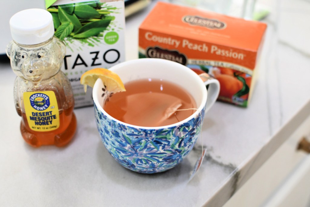 cup of diy starbucks medicine ball tea next to ingredients on the counter