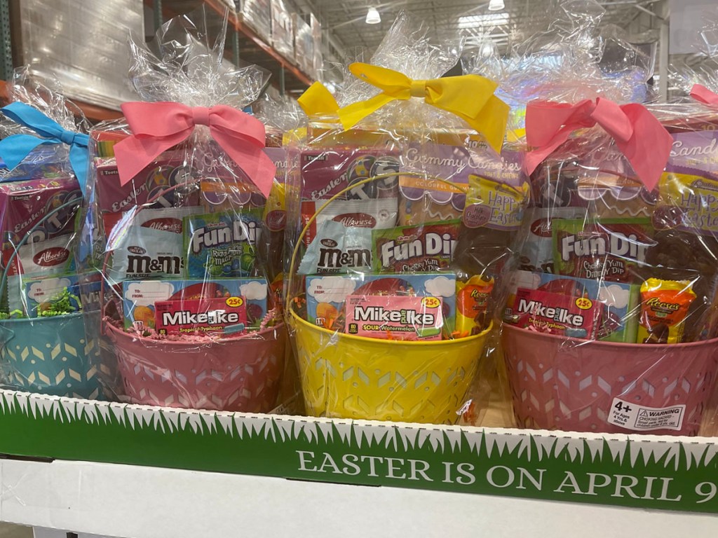 blue, pink, yellow and pink easter baskets full of candy on shelf