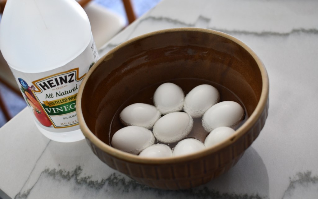 bowl of eggs soaking in white vinegar 