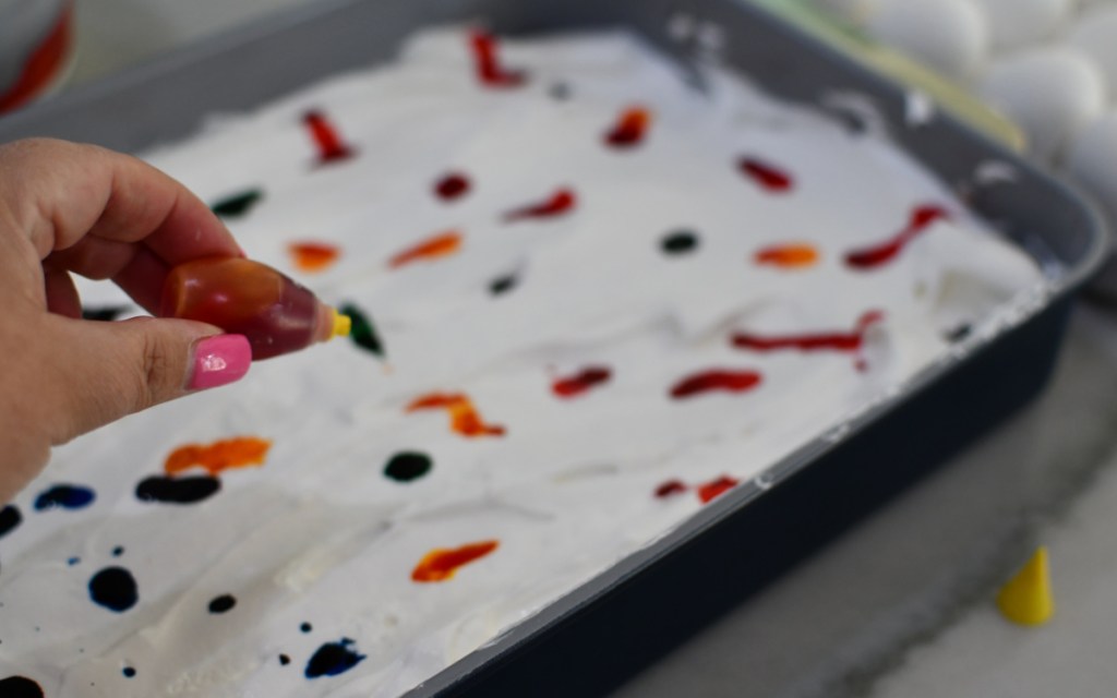 food coloring drops on whipped cream