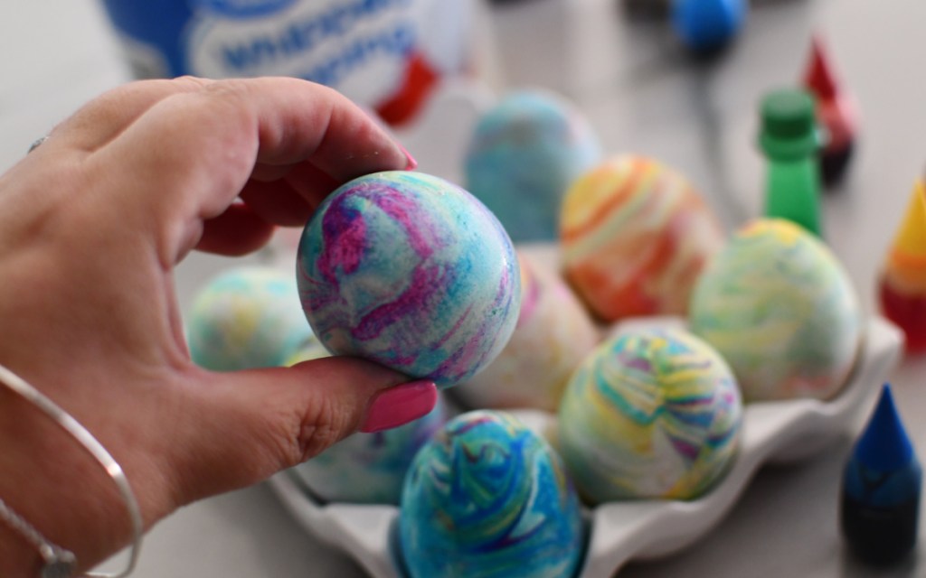 holding tie dye egg