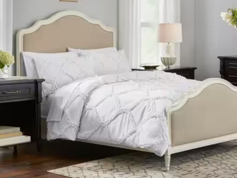 white ogee boho style onlineforter and sham set on a bed with a vintage style headboard