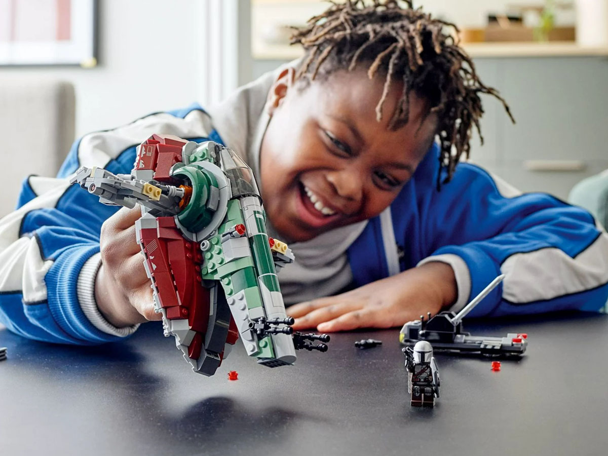 boy playing with boba fet lego set 