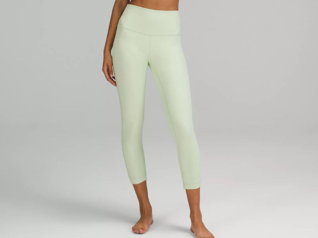 Woman wearing a pair of light green leggings