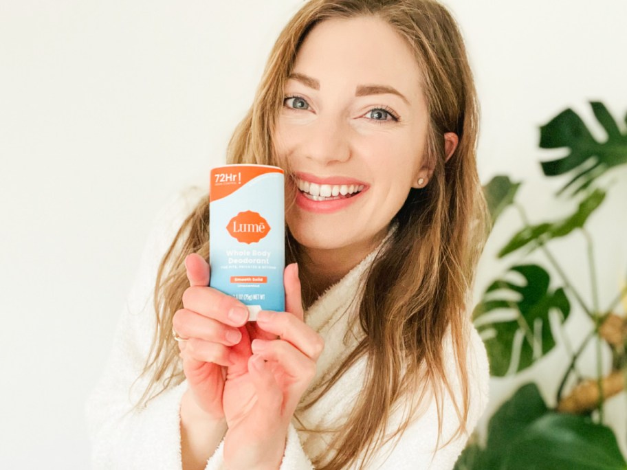 woman holding stick deodorant