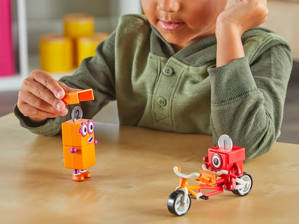 child playing with numberblocks figurines