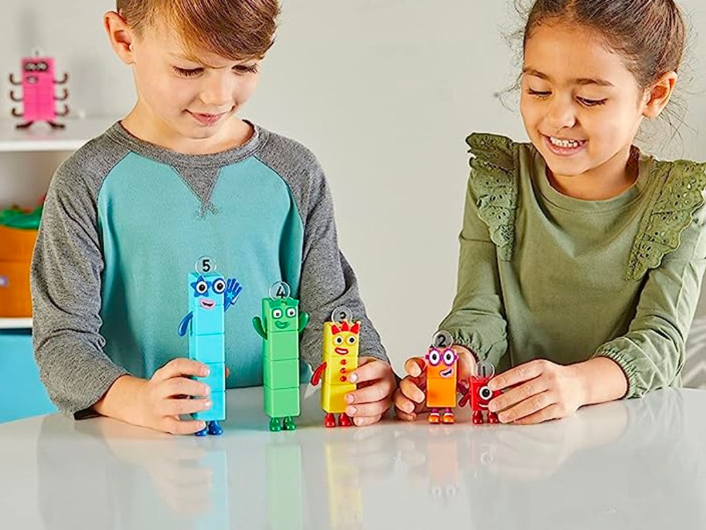 child playing with numberblocks figurines