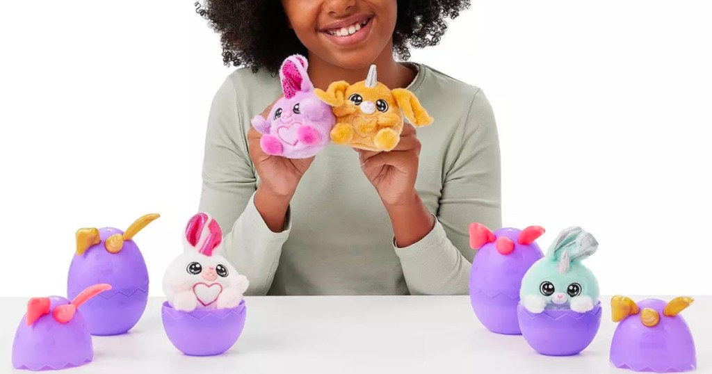 girl playing with rainbocorn bunny toys