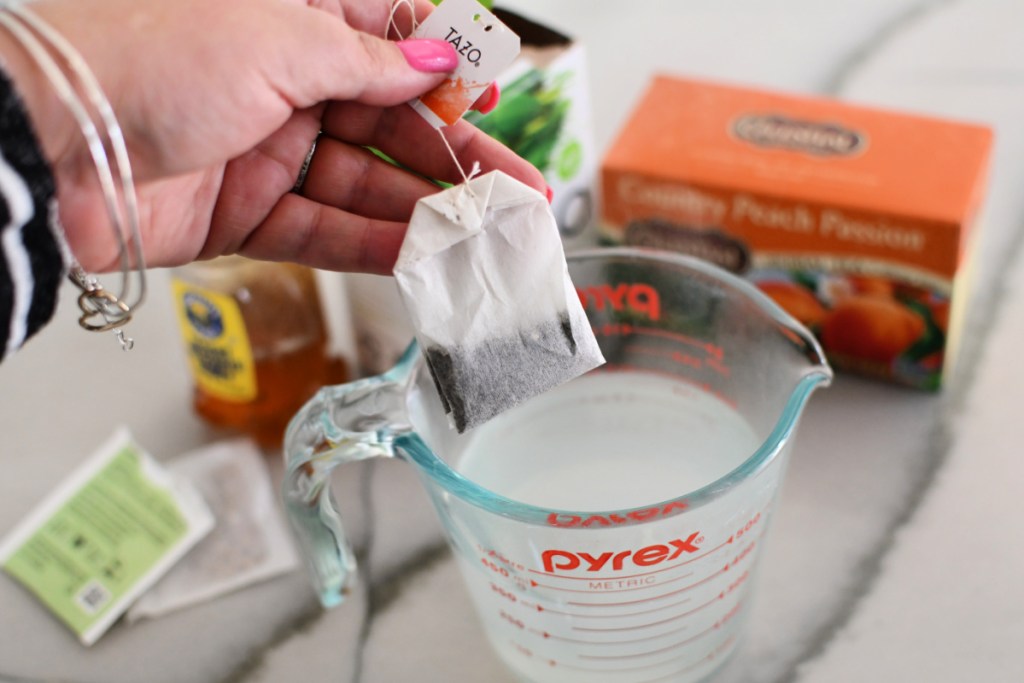 steeping tea in hot water to make a medicine ball