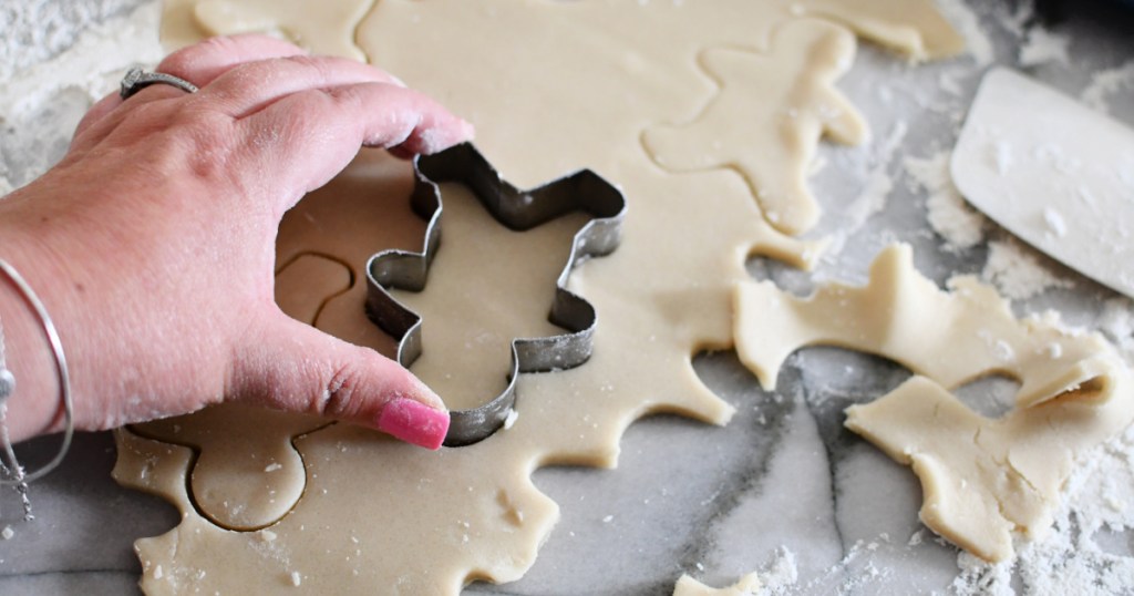 using a cutter cutter on sugar cookie dough