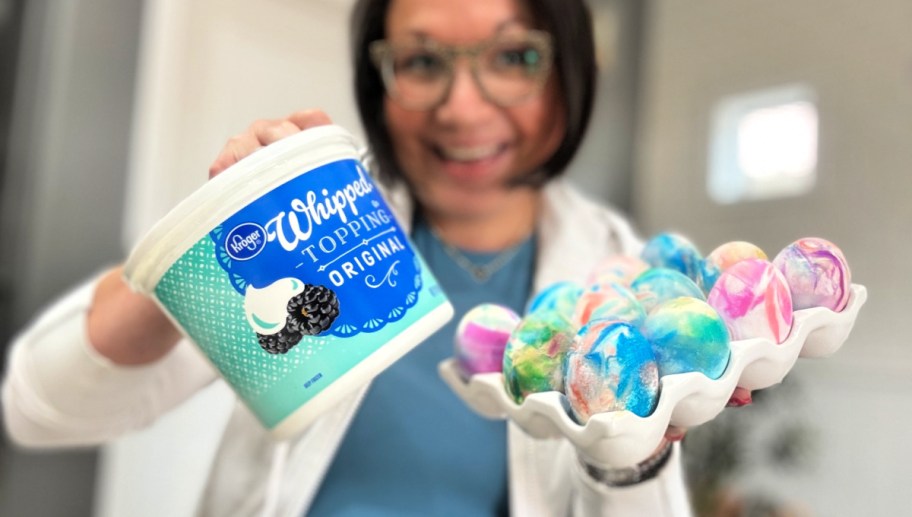 woman holding whipped topping easter eggs 