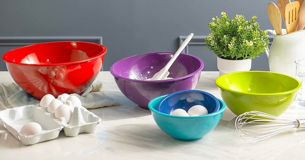 zak mixing bowl set in a variety of colors with eggs, and flour in bowls