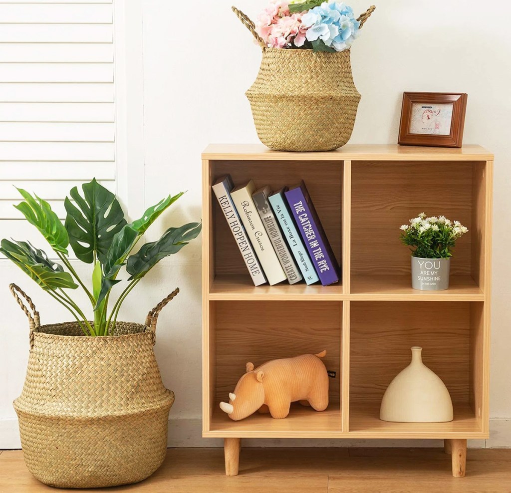 two wicket baskets next to and on top of a wood bookcase