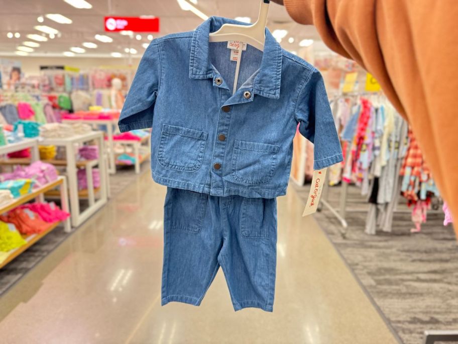 A hand holding a Cat & Jack Denim 2-Piece Kids Outfit