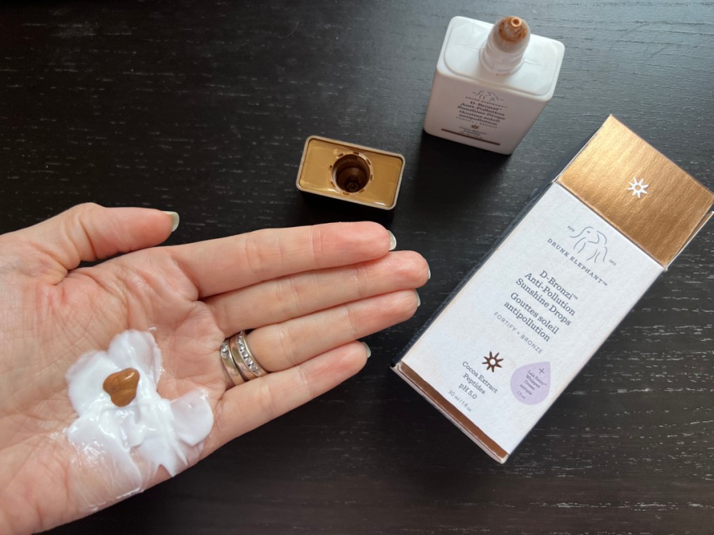 Woman mixing bronzer with moisturizer