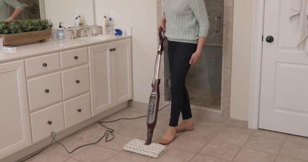 woman mopping a bathroom floor with a Shark Genius Steam Pocket Mop with Accessories 