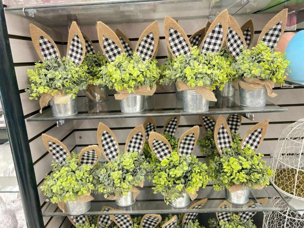 table centerpiece with greenery and wood rabbit ears with gingham ribbon