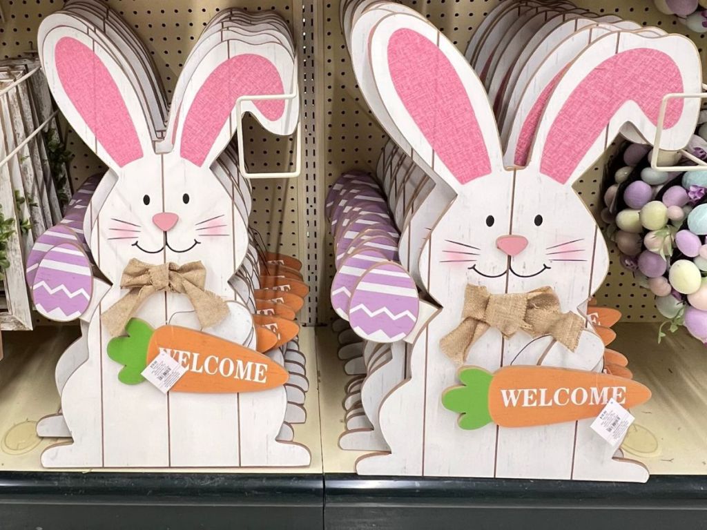 large wood white Easter rabbit sign holding a carrot that says "welonlinee"