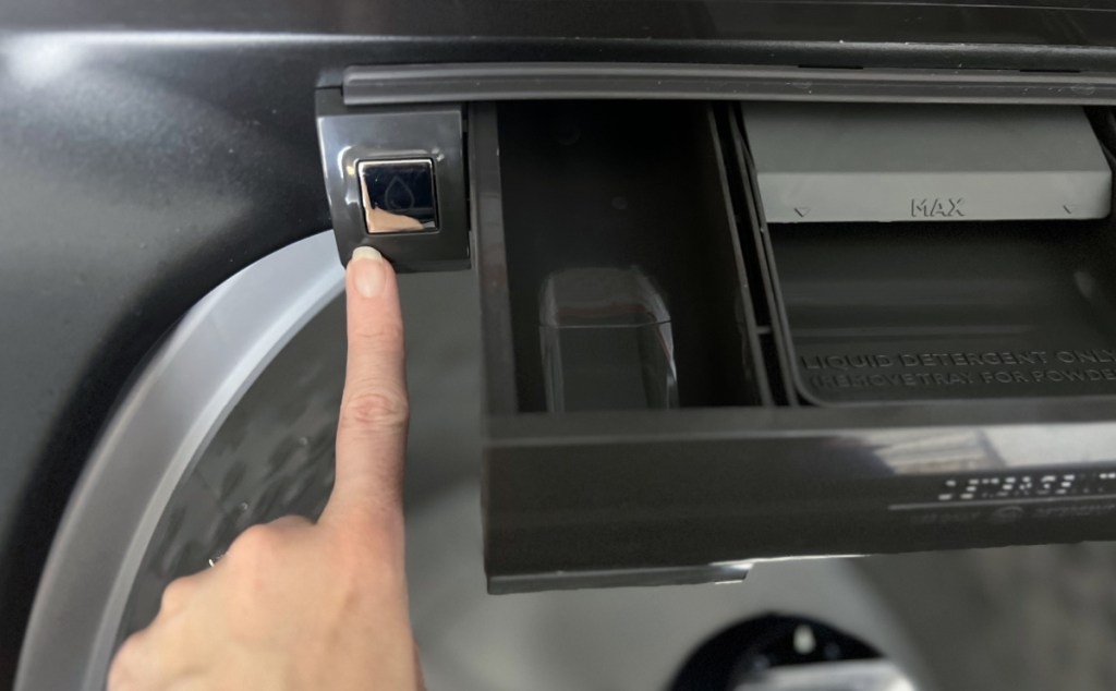 woman pointing to the built-in faucet on her washing machine