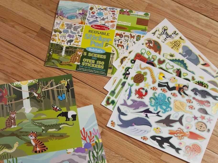 Melissa & Doug Reusable Sticker Pad with the sticker sheets spread across the floor