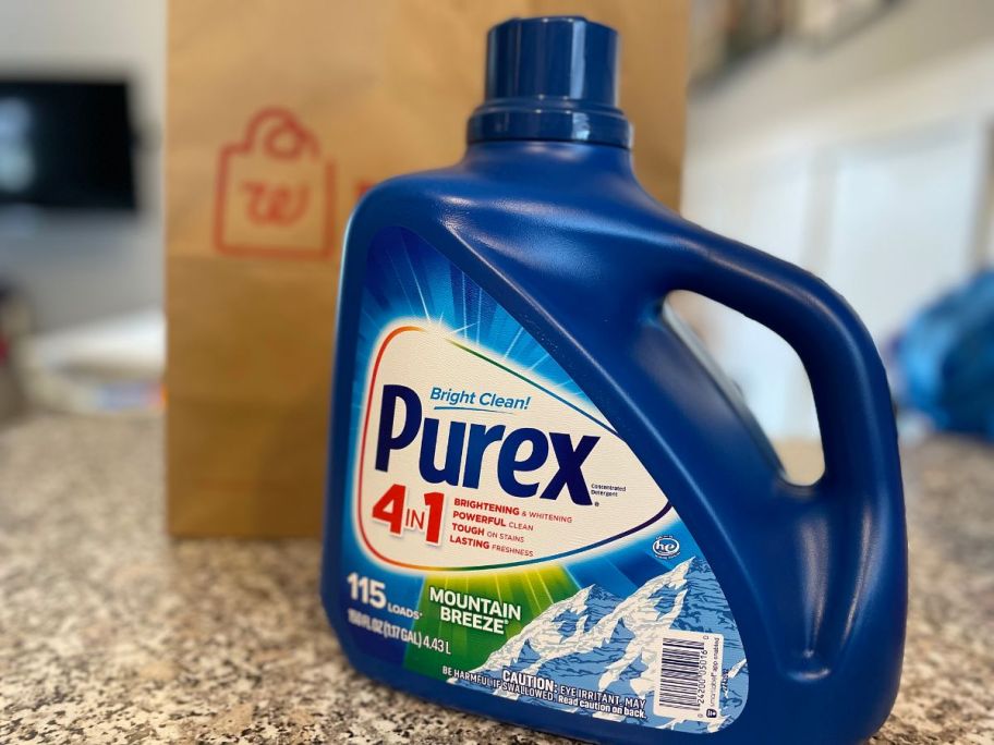 a large bottle of Purex laundry detergent on a kitchen counter