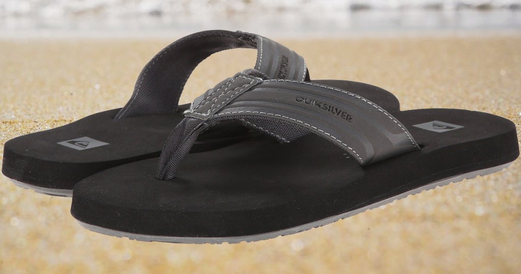 pair of quicksilver flip flops on sand