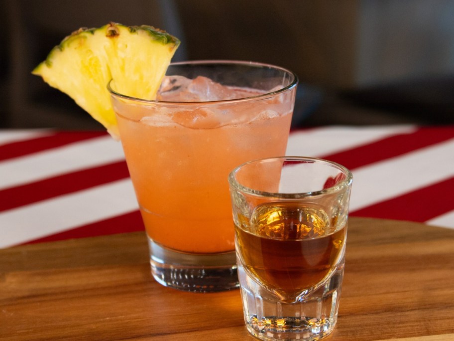 two cocktails on a wooden bar