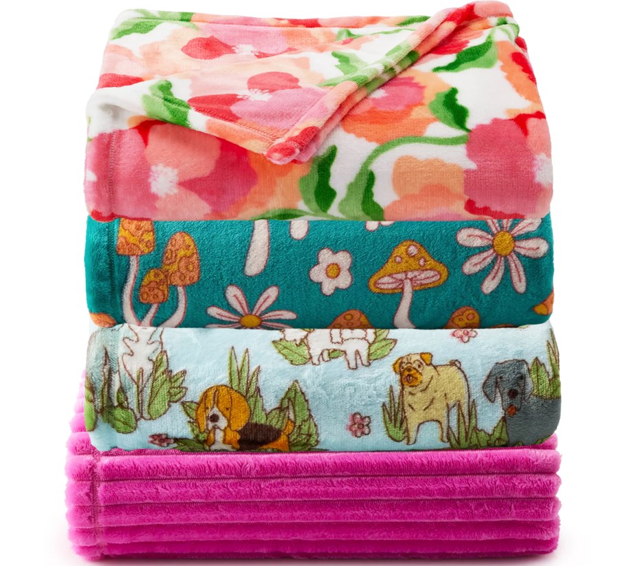 folded stack of printed throw blankets