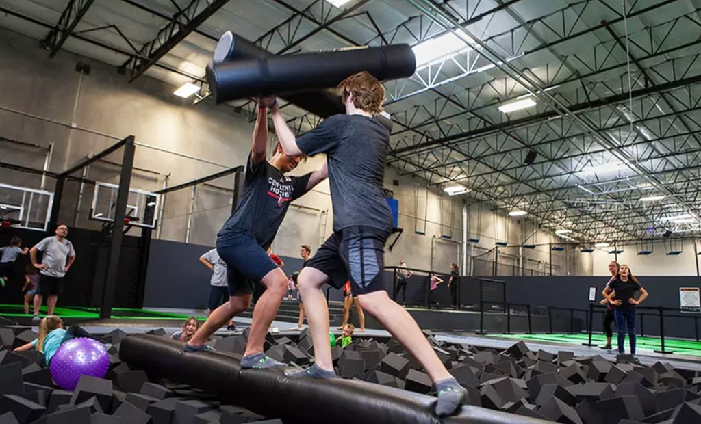 kids playing near foam pit at trampoline park