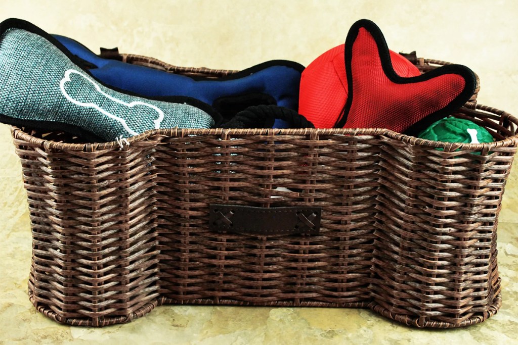 brown bone shaped basket with dog toys inside