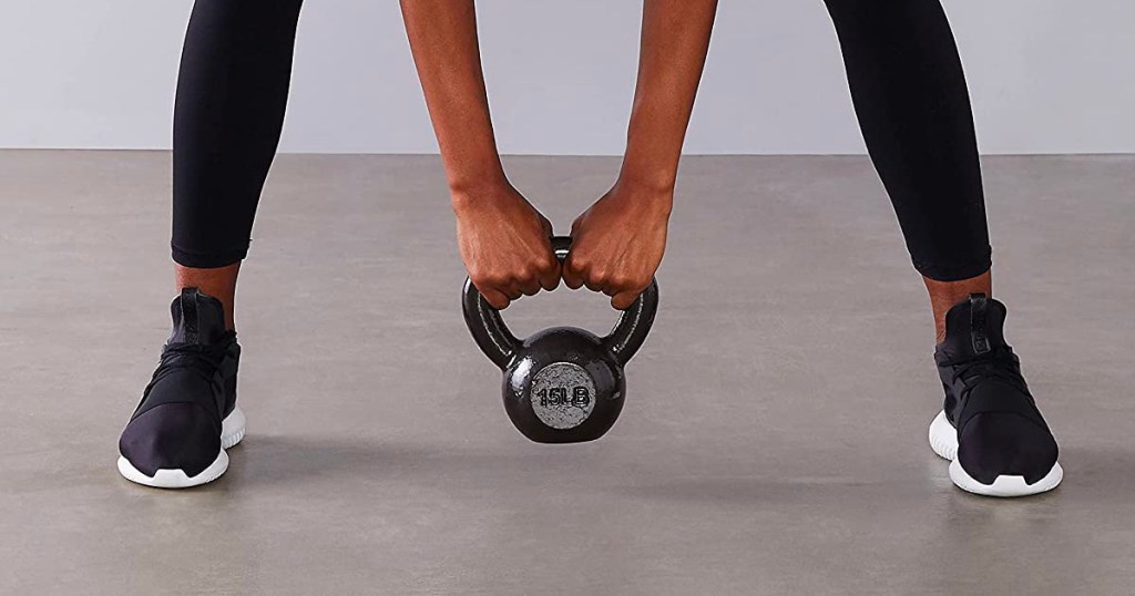 woman holding 15 pound kettleball