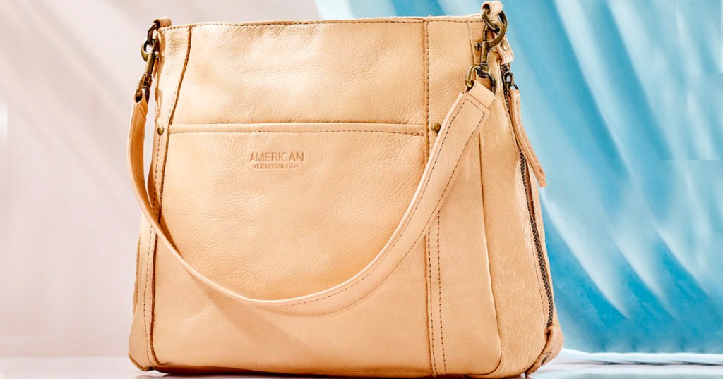 beige american leather shoulder bag on blue background