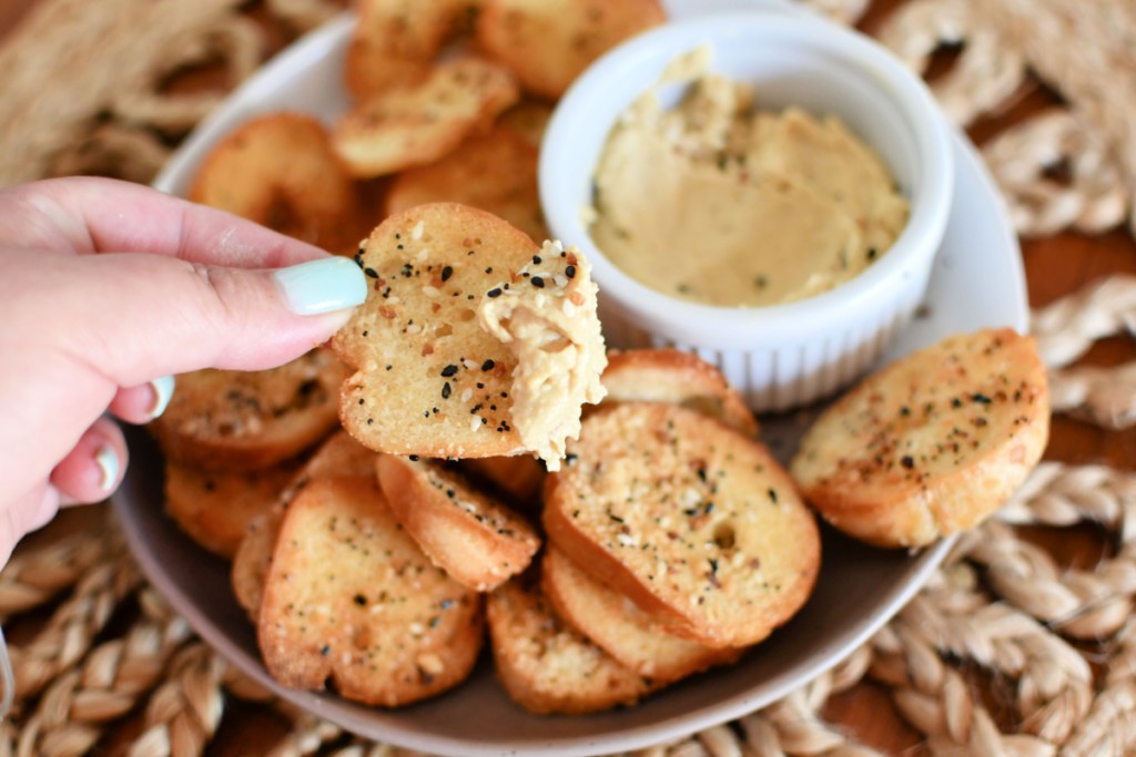 bagel chips dipped in hummus