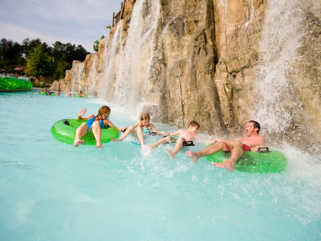 family at waterpark on green innertubes