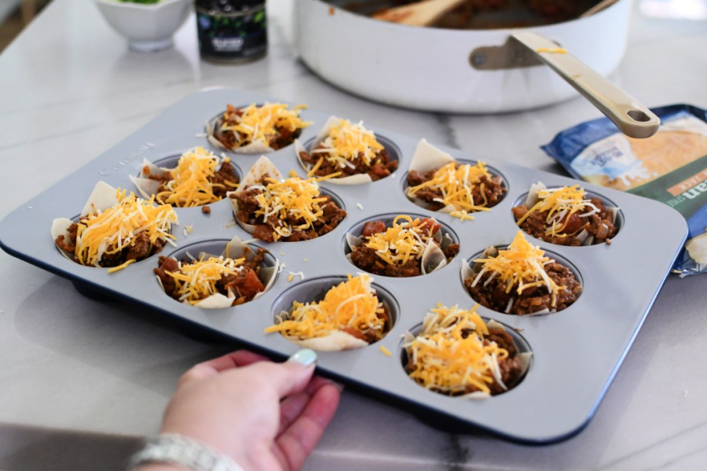 holding a caraway muffin pan of wanton cups before baking