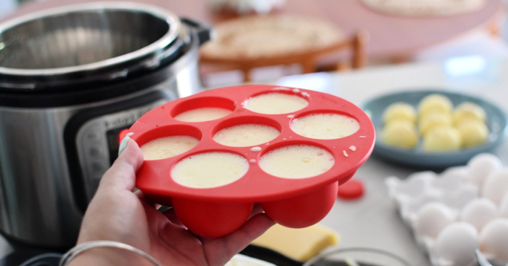 holding up an egg bite mold before cooking