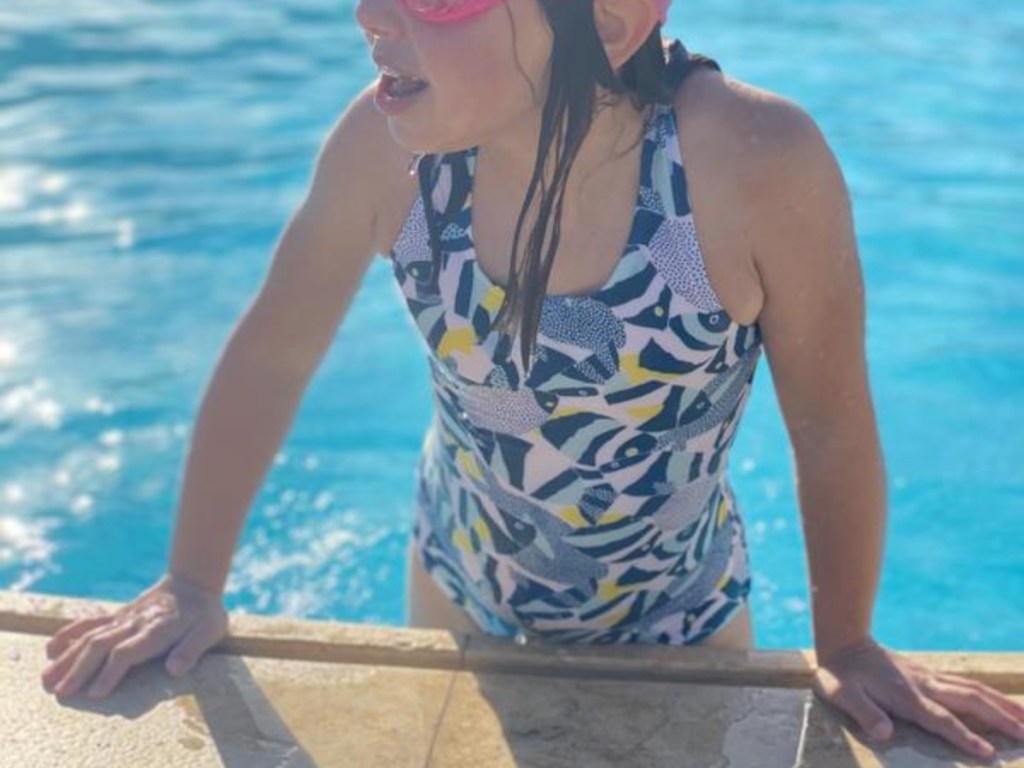 girl emerging from pool