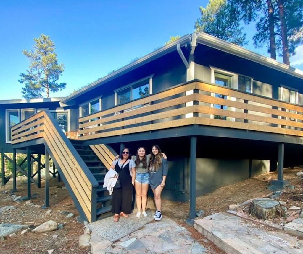 women standing outside of airbnb